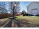Spacious backyard with mature trees, lawn, and a peaceful ambiance at 712 Ledgerock Rd, Wake Forest, NC 27587