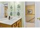 Bright bathroom featuring green walls, white counter and mirror, and access to upstairs at 712 Ledgerock Rd, Wake Forest, NC 27587