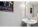 Charming half bathroom with pedestal sink and decorative wall art at 712 Ledgerock Rd, Wake Forest, NC 27587