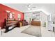 Spacious bedroom boasts a large window, red accent wall, and ceiling fan at 712 Ledgerock Rd, Wake Forest, NC 27587