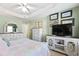 Cozy bedroom featuring a tray ceiling, a ceiling fan, neutral walls and elegant white furniture at 712 Ledgerock Rd, Wake Forest, NC 27587