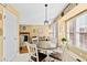Bright kitchen nook features a round table and bay window with a view to the backyard at 712 Ledgerock Rd, Wake Forest, NC 27587