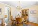 Dining area with wooden table and chairs, decorative accents, and adjacent doorway to another room at 712 Ledgerock Rd, Wake Forest, NC 27587