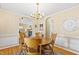 Well-lit dining room featuring a round table and wooden chairs with adjacent rooms in view at 712 Ledgerock Rd, Wake Forest, NC 27587