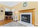 Close-up of fireplace with decorative mantel, tiled hearth, and hardwood floors at 712 Ledgerock Rd, Wake Forest, NC 27587