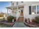 Charming front porch featuring brick steps and decorated with seasonal decor at 712 Ledgerock Rd, Wake Forest, NC 27587