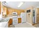 Functional kitchen with oak cabinets, white appliances, white countertops and double sink at 712 Ledgerock Rd, Wake Forest, NC 27587