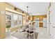 Eat-in kitchen with wood cabinets, modern appliances, and dining area with bright sunlight at 712 Ledgerock Rd, Wake Forest, NC 27587