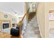 Carpeted staircase leading to the upper level, adjacent to a cozy living space at 712 Ledgerock Rd, Wake Forest, NC 27587