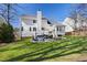 Spacious home back exterior with a well-manicured lawn, deck, and inviting patio area at 804 Chancellors Ridge Dr, Durham, NC 27713