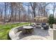 Spacious backyard featuring an outdoor dining area, a fire pit, and comfortable seating at 804 Chancellors Ridge Dr, Durham, NC 27713