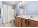 Bathroom featuring a double sink vanity and a shower tub with a shower curtain at 804 Chancellors Ridge Dr, Durham, NC 27713