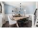 Elegant dining room with a large wooden table, stylish chairs, and modern lighting at 804 Chancellors Ridge Dr, Durham, NC 27713
