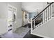 Elegant foyer with dark wood floors, a staircase, and a view into the dining area at 804 Chancellors Ridge Dr, Durham, NC 27713