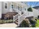 Inviting front porch with white railings and brick accents, surrounded by landscaping at 804 Chancellors Ridge Dr, Durham, NC 27713