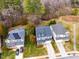 Aerial view of a well-maintained neighborhood with manicured lawns, mature trees and gray homes at 812 Long Meadows Rd, Chapel Hill, NC 27516