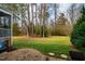 Spacious backyard featuring a patio and mature trees, offering a serene outdoor retreat at 812 Long Meadows Rd, Chapel Hill, NC 27516