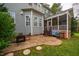 Backyard patio with room to entertain, adjacent to a screened in porch on a home with gray siding at 812 Long Meadows Rd, Chapel Hill, NC 27516