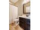 Bathroom featuring a dark vanity, framed mirror, a white toilet and a shower with a shower curtain at 812 Long Meadows Rd, Chapel Hill, NC 27516