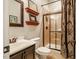 Well-lit bathroom with a shower, vanity with sink, and decorative shelves at 812 Long Meadows Rd, Chapel Hill, NC 27516