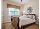 Cozy bedroom featuring a queen bed, neutral colors, and natural light from the window at 812 Long Meadows Rd, Chapel Hill, NC 27516