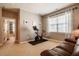 Exercise room with a stationary bike, a view of the hallway and a comfortable leather couch at 812 Long Meadows Rd, Chapel Hill, NC 27516
