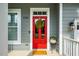 Inviting red front door with a festive wreath, complemented by neat landscaping and the 'WELCOME' mat at 812 Long Meadows Rd, Chapel Hill, NC 27516