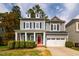 Charming two-story home with a welcoming front porch, neat landscaping, and a two-car garage at 812 Long Meadows Rd, Chapel Hill, NC 27516