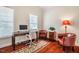 Bright home office with a dark desk, hardwood floors and comfortable leather chairs at 812 Long Meadows Rd, Chapel Hill, NC 27516