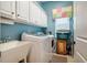 Practical laundry room with white cabinets, sink, washer, and dryer at 812 Long Meadows Rd, Chapel Hill, NC 27516