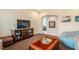 Cozy living room featuring a TV over a sideboard, an arched entry and hardwood coffee table at 812 Long Meadows Rd, Chapel Hill, NC 27516