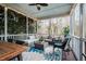 Relaxing screened porch with comfortable seating and a view of the backyard at 812 Long Meadows Rd, Chapel Hill, NC 27516
