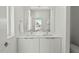 Bright bathroom featuring a double sink vanity with modern fixtures and a large mirror at 813 N Mangum St, Durham, NC 27701