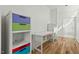 Bedroom featuring playful decor, with hardwood floors and bright, painted built-in storage at 813 N Mangum St, Durham, NC 27701