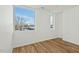 A bright bedroom offers natural light, complemented by elegant hardwood flooring and neutral walls at 813 N Mangum St, Durham, NC 27701