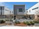 Modern two-story home with gray and brick facade and manicured front yard featuring a small seating area at 813 N Mangum St, Durham, NC 27701
