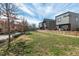 Modern townhomes featuring a central green space and stylish architectural details under a partially cloudy blue sky at 813 N Mangum St, Durham, NC 27701