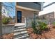 Contemporary home entrance with brick facade, concrete steps, and well-maintained landscaping at 813 N Mangum St, Durham, NC 27701