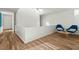 Bright hallway with wood floors, white walls, and minimalist modern furniture at 813 N Mangum St, Durham, NC 27701