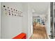 Hallway with light wood floors, modern coat rack, and an open view into the living area at 813 N Mangum St, Durham, NC 27701