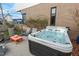 Backyard with a luxurious hot tub surrounded by lounge seating and decorative elements at 813 N Mangum St, Durham, NC 27701