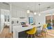 Modern kitchen with white cabinets, sleek appliances, and an island with seating, perfect for culinary enthusiasts at 813 N Mangum St, Durham, NC 27701