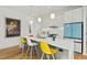 Modern kitchen island with white countertop, gray cabinets, and pendant lighting, ideal for cooking at 813 N Mangum St, Durham, NC 27701
