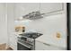 Close-up of a well-equipped kitchen with stainless steel appliances and sleek white cabinetry at 813 N Mangum St, Durham, NC 27701