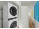 Modern laundry room featuring a stacked washer and dryer for space-saving convenience at 813 N Mangum St, Durham, NC 27701