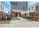 Exterior view of modern townhomes with driveways, landscaping, and contemporary design elements at 813 N Mangum St, Durham, NC 27701