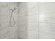 Stylish shower with marble tile surround and a sleek, modern shower head fixture at 813 N Mangum St, Durham, NC 27701