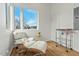 Cozy sitting area with a modern chair, large window, and a bar cart for entertaining at 813 N Mangum St, Durham, NC 27701