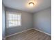 Cozy bedroom featuring modern gray walls, durable wood-look flooring, and a bright window at 817 S Brake St, Nashville, NC 27856