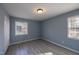 Bright bedroom features stylish gray walls, durable wood-look flooring, and double windows at 817 S Brake St, Nashville, NC 27856